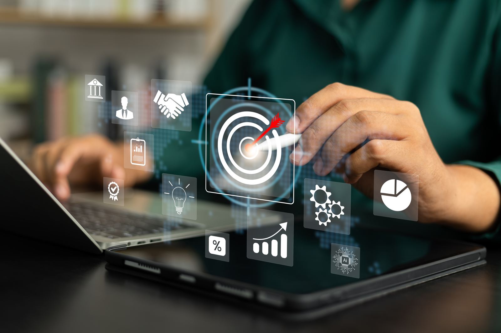 A reviewer working through report and workflow icons on a laptop screen